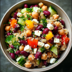 Salade de quinoa et pois chiches, betteraves rôties et feta servie dans un grand saladier coloré